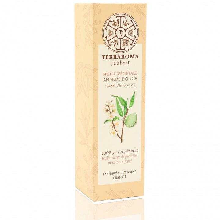 Boîte de l'huile végétale d'amande douce Terraroma Jaubert, avec un design crème clair. L'étiquette présente une illustration de branche d'amandier avec une amande et des fleurs. Le logo de la marque est en haut, accompagné du texte : '100% pure et naturelle, huile vierge de première pression à froid, fabriquée en Provence, France'.